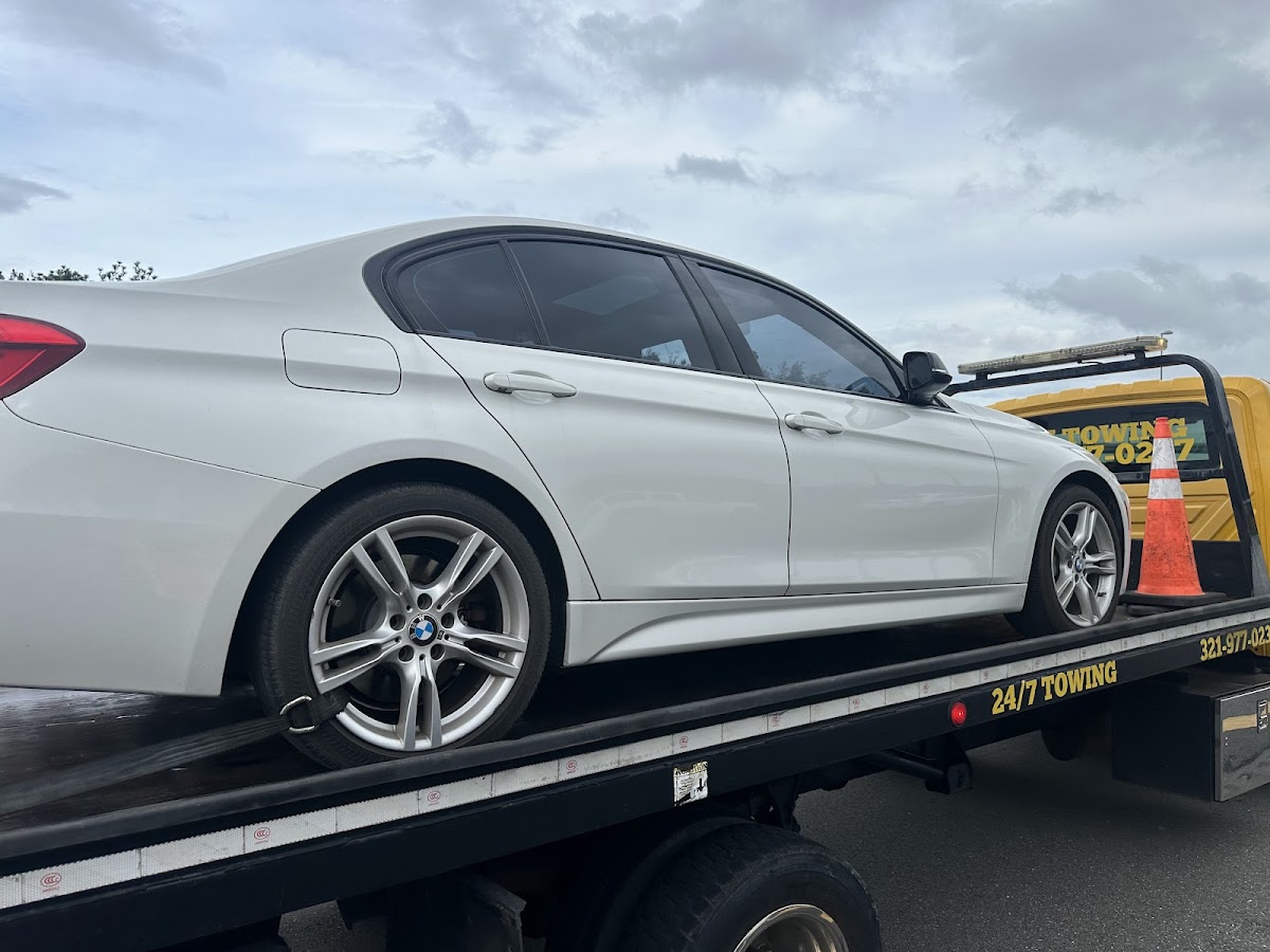 BMW loaded on flatbed tow truck